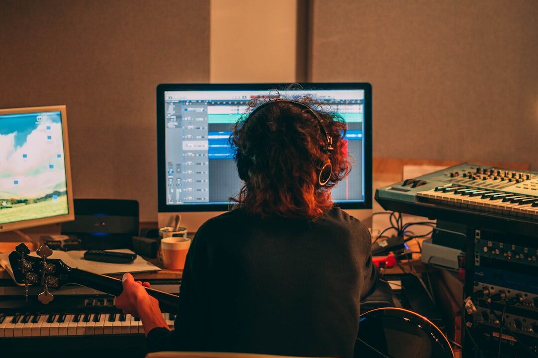 Sound engineer working at a mixing console in a professional recording studio